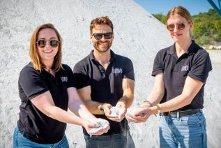 Members of the UNDO team holding crushed wollastonite.